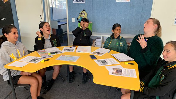 Intermediate students laughing with teacher